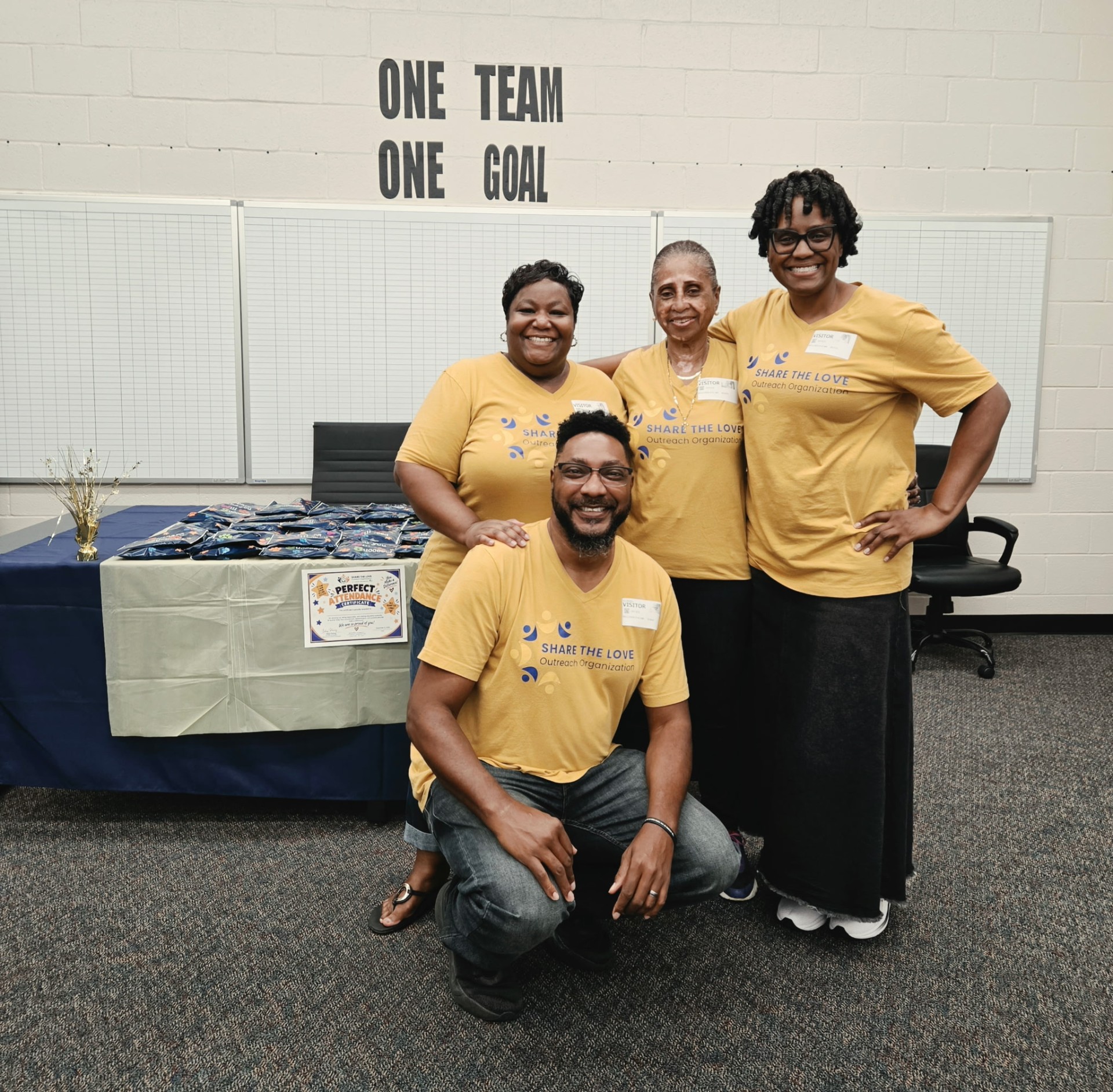 Share the Love volunteers gathered at the perfect attendance celebration table