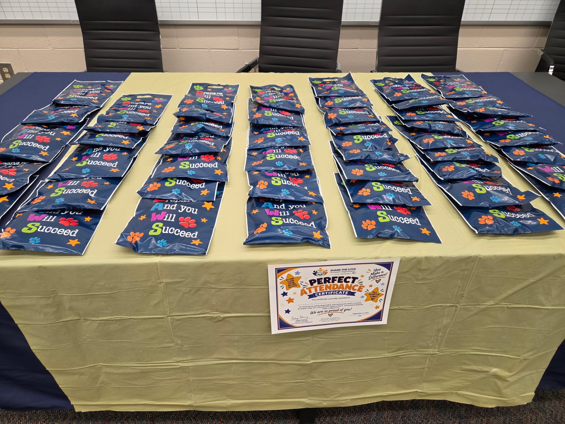 Goodie bags and Perfect Attendance certificates lined up for the Sanders Elementary celebration