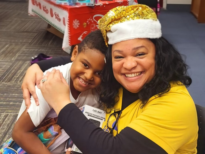 Volunteers preparing wrapped Christmas gifts for children and families